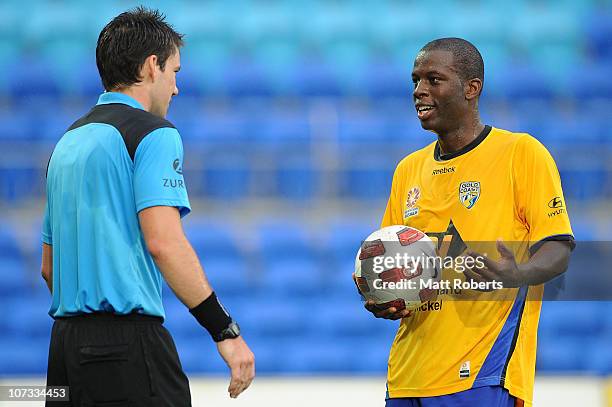 Bruce Djite of the Gold Coast talks with the referee during the round 17 A-League match between Gold Coast United and the Melbourne Heart at Skilled...