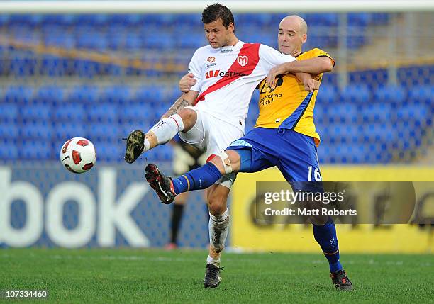 Nicholas Kalmar of the Heart contests the ball with Kristian Rees of the Gold Coast during the round 17 A-League match between Gold Coast United and...