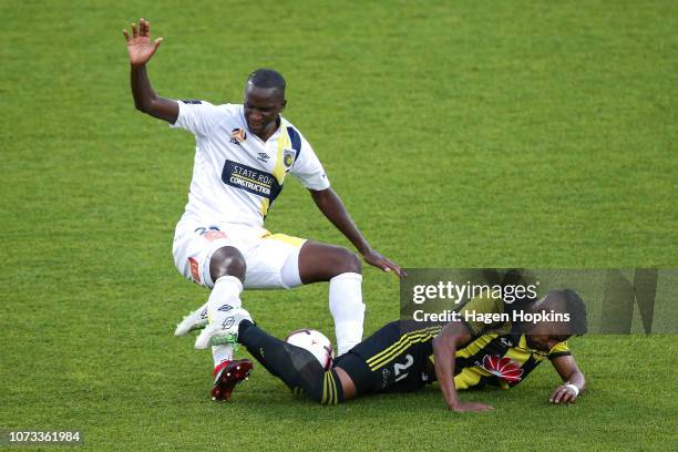 Roy Krishna of the Phoenix is tackled by Kalifa Cisse of the Mariners during the round eight A-League match between the Wellington Phoenix and the...