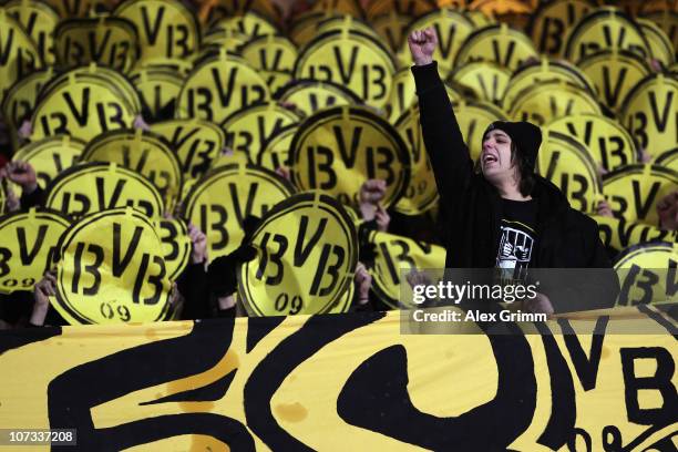 Supporters of Dortmund cheer before the Bundesliga match between 1. FC Nuernberg and Borussia Dortmund at Easy Credit Stadium on December 5, 2010 in...