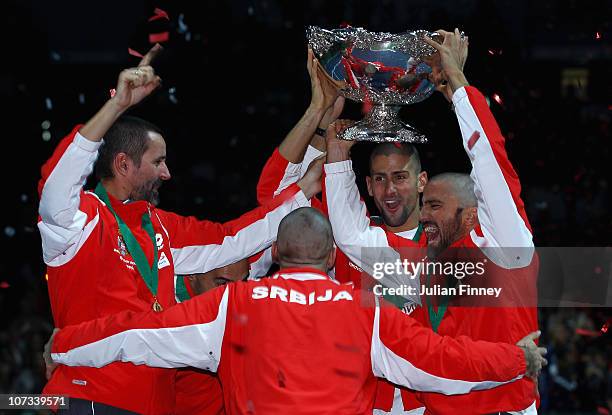 Bogdan Obradovic, Nenad Zimonjic, Novak Djokovic, Janko Tipsarevic and Viktor Troicki of Serbia celebrate with the trophy after defeating France...