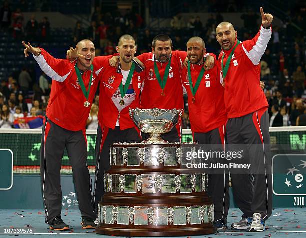 Bogdan Obradovic, Nenad Zimonjic, Novak Djokovic, Janko Tipsarevic and Viktor Troicki of Serbia celebrate with the trophy after defeating France...