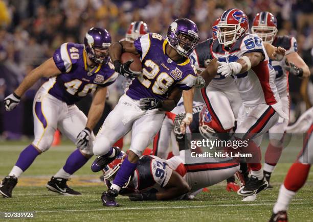 Adrian Peterson of the Minnesota Vikings rushes against the Buffalo Bills at the Mall of America Field at the Hubert H. Humphrey Metrodome on...