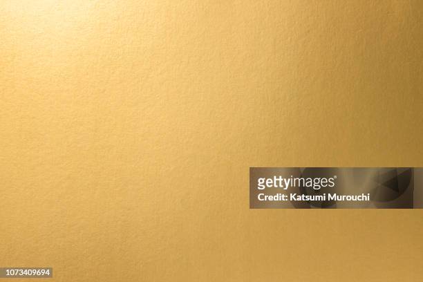 golden paper texture background - gold coloured stock pictures, royalty-free photos & images