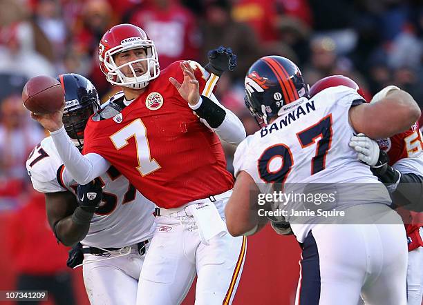 Quarterback Matt Cassel of the Kansas City Chiefs is pressured by Mario Haggan and Justin Bannan of the Denver Broncos during the game on December 5,...