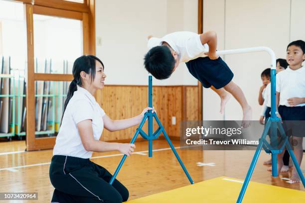 young children practicing gymnastics at preschool in japan - school gymnastics 個照片及圖片檔