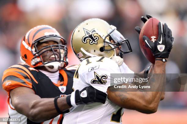 Robert Meachem of the New Orleans Saints catches pass while defended by Chinedum Ndukwe of the Cincinnati Bengals during the NFL game at Paul Brown...