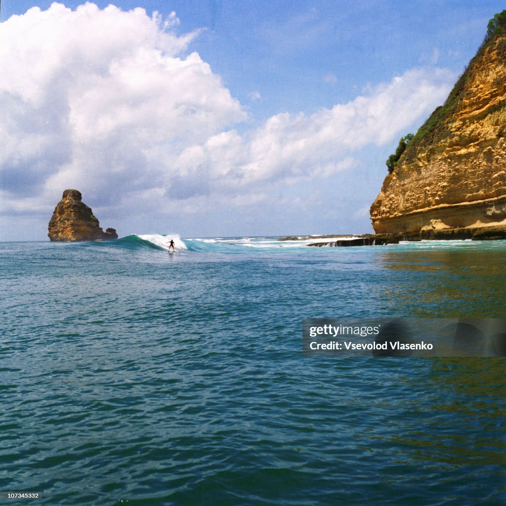 Surfer riding wave at Gerupuk outside