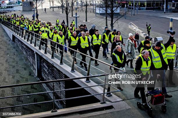 Protestors wearing yellow vests demonstrate on the Erasmusbrug in the centre of Rotterdam, on December 15, 2018. - The so-called gilets jaunes...