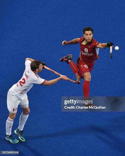 Cedric Charlier of Belgium attempts to claim the ball from Michael Hoare of England during the FIH Men's Hockey World Cup Semi-Final match between...