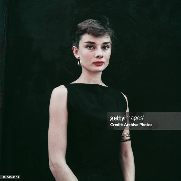 Belgian-born actress Audrey Hepburn in a black sleeveless dress, circa 1955.