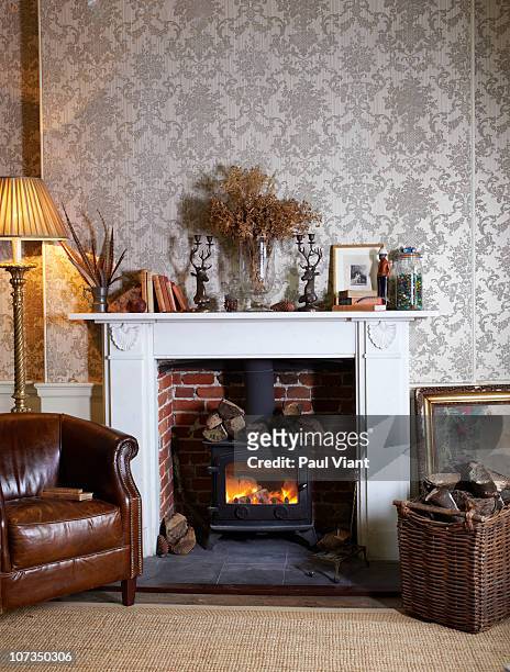 fireplace with log burner - shabby chic stockfoto's en -beelden