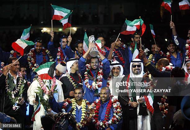 Kuwaiti national football team goalkeeper and captain Nawaf al-Khaldi holds the GCC cup trophy during a celebration upon the team's return to Kuwait...