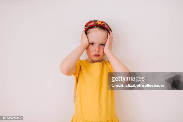 portrait of a girl with a headache - headache child fotografías e imágenes de stock
