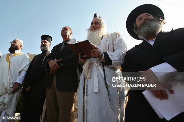 An Muslim imam , a Christian priest and two Jewish rabbis join a prayer calling for rain on November 11, 2010 in the West Bank village of Walajeh...