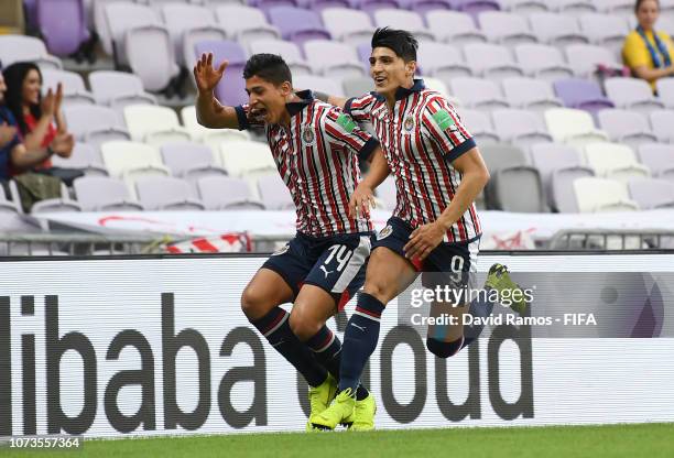 Angel Zaldivar of CD Guadalajara celebrates with teammate Alan Pulido after scoring his team's first goal during the FIFA Club World Cup UAE 2018...