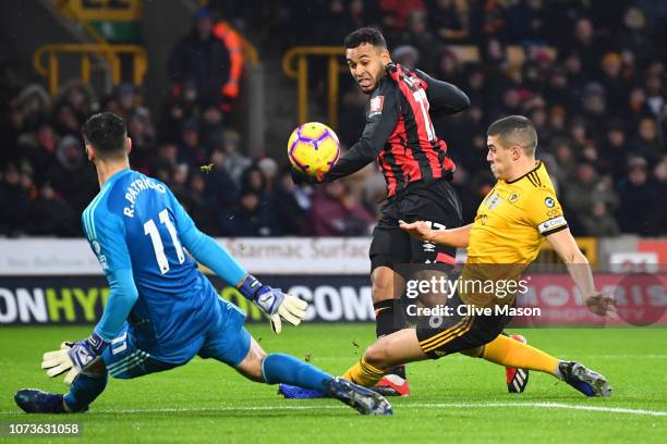 Joshua King of AFC Bournemouth shoots while under pressure from Conor Coady of Wolverhampton Wanderers during the Premier League match between...