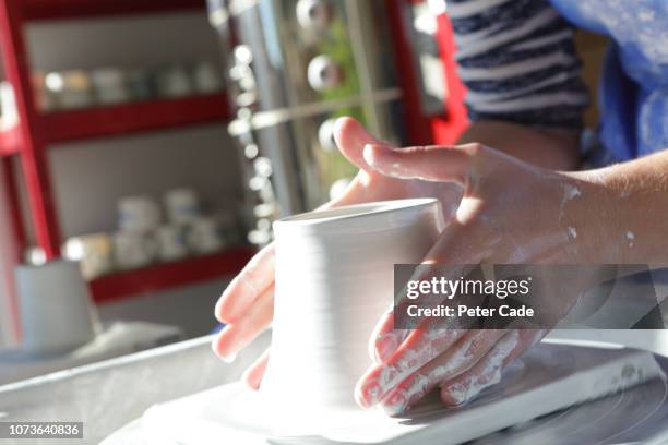 woman creating pottery in workshop - potter stock pictures, royalty-free photos & images