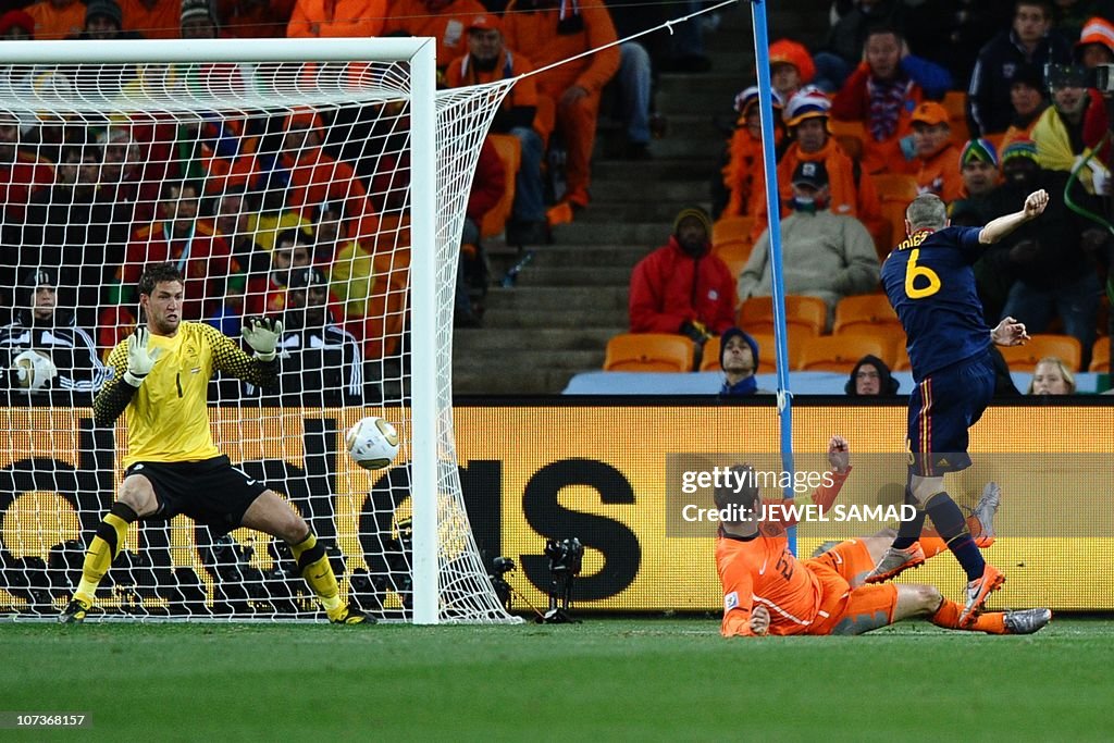 Spain's midfielder Andrés Iniesta (R) sh