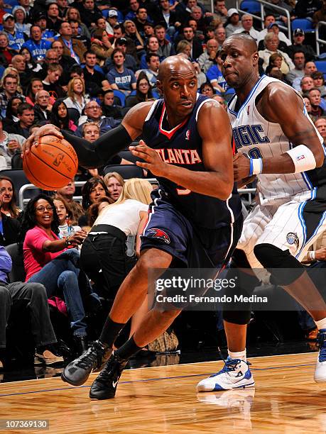 Damien Wilkins of the Atlanta Hawks moves the ball against Mickael Pietrus of the Orlando Magic on December 6, 2010 at the Amway Center in Orlando,...