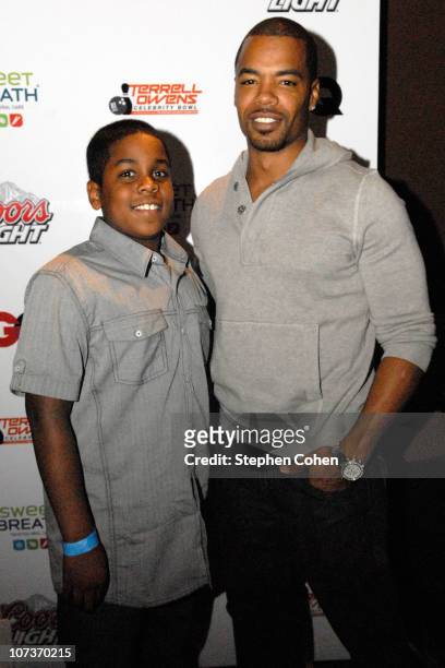 Aeneas Hawkins and father Artrell Hawkins attend the 81 Cares Bowl presented by Terrell Owens and GQ Magazine at Star Lanes On The Levee on December...