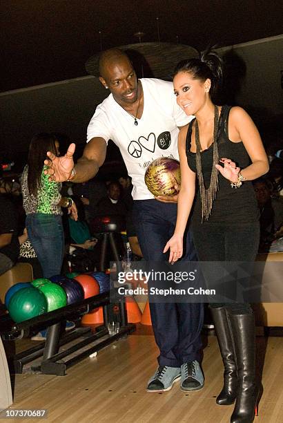 Terrell Owens and Adrienne Bailon attend the 81 Cares Bowl presented by Terrell Owens and GQ Magazine at Star Lanes On The Levee on December 6, 2010...