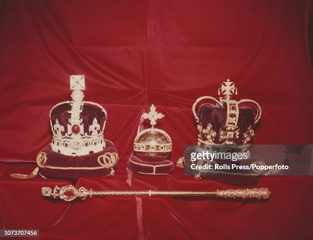 View of a small selection the Crown Jewels of the United Kingdom featuring St Edward's Crown on right, the orb in centre and sceptre with cross, on...