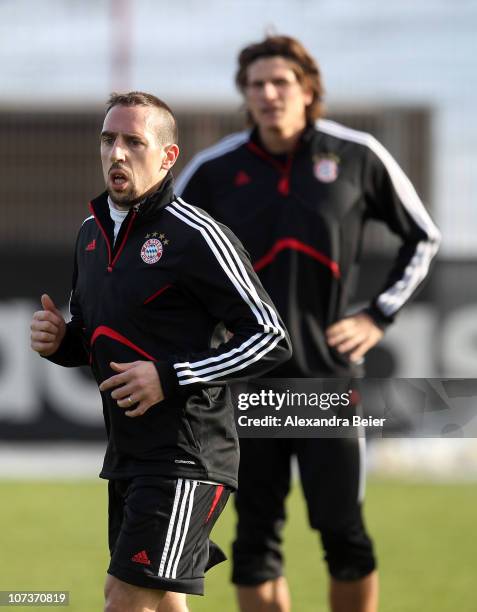 Franck Ribery and Mario Gomez exercise during a Bayern Muenchen training session ahead of the Champions League Group E match against FC Basel on...