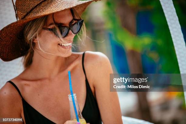 beautiful smiling woman drinking juice at the pool - hot female models stock pictures, royalty-free photos & images