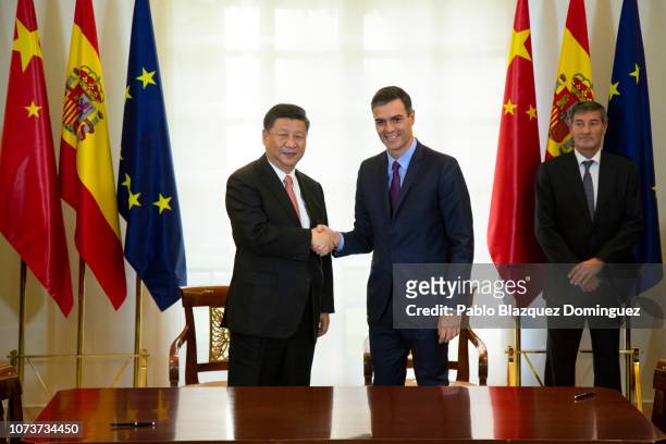 Spanish Prime Minister Pedro Sanchez shakes hands with Chinese President Xi Jinping after signing agreements between both countries at Moncloa Palace...