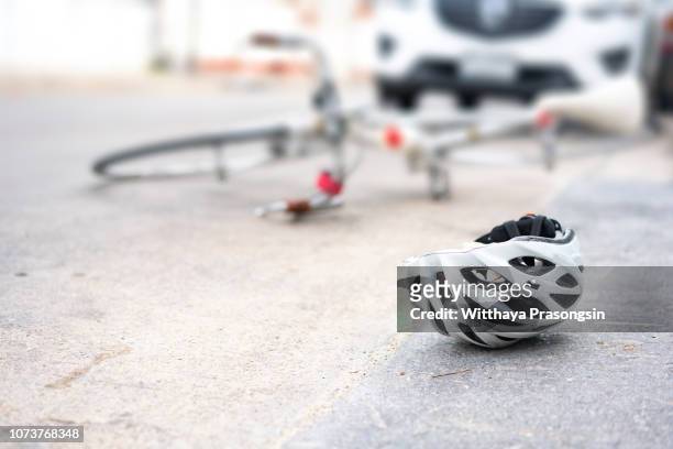 helmet and bike lying on the road after a car hit a cyclist on a pedestrian crossing - motorcycle crash stock pictures, royalty-free photos & images