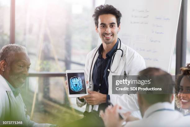 confident male doctor discusses human brain - neurologist stock pictures, royalty-free photos & images