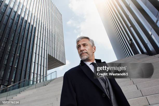 portrait of fashionable businessman in front of modern architecture - fashionable man stock pictures, royalty-free photos & images
