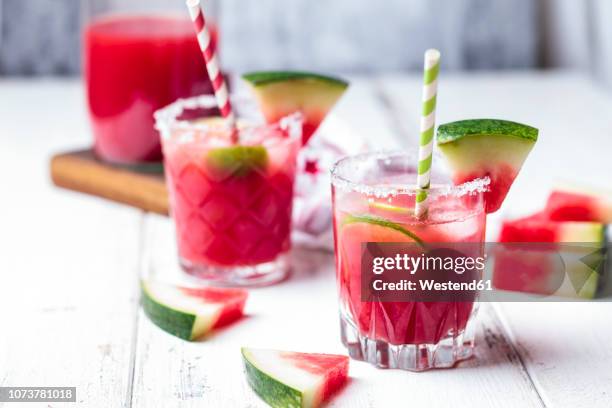 glasses of melon margarita with watermelon juice - watermelon juice stock pictures, royalty-free photos & images