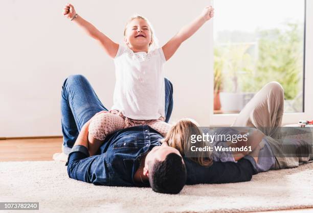 happy girl at home with her parents - mom cheering stock pictures, royalty-free photos & images