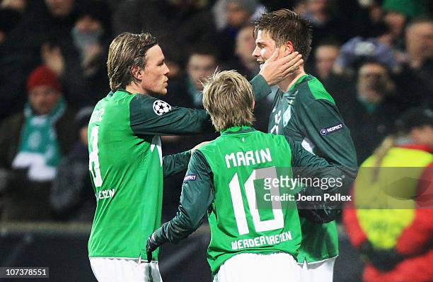 Sebastian Proedl of Bremen celebrates with his team mates Clemens Fritz and Marko Marin after scoring his team's first goal during the UEFA Champions...