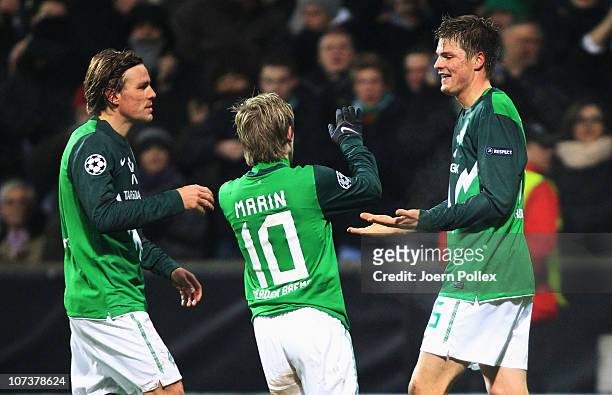 Sebastian Proedl of Bremen celebrates with his team mates Clemens Fritz and Marko Marin after scoring his team's first goal during the UEFA Champions...
