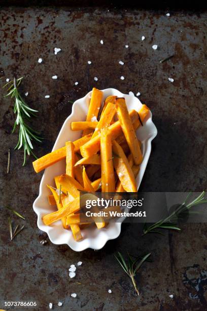 sweet potato fries with rosmary and salt in porcelain bowl - sweet potato fries stock pictures, royalty-free photos & images