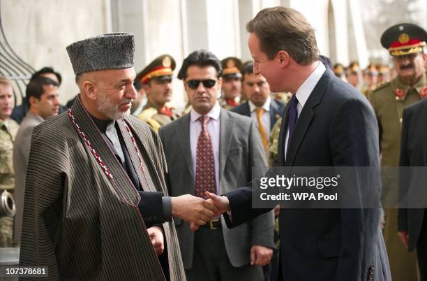 British Prime Minister David Cameron is greeted upon arrival by Afghan President Hamid Karzai on December 7, 2010 in Kabul, Afghanistan. The leaders...