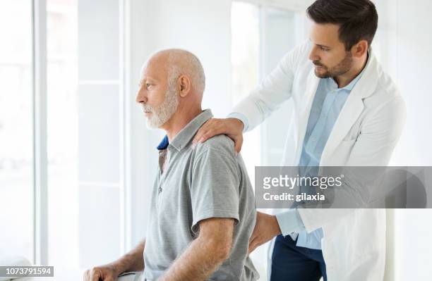 lower back pain medical examination. - dislocation stock pictures, royalty-free photos & images