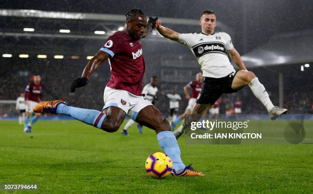 West Ham United's English midfielder Michail Antonio vies with Fulham's English defender Joe Bryan during the English Premier League football match...