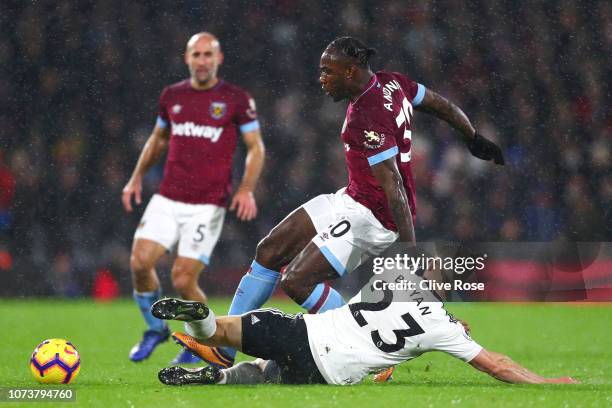 Joe Bryan of Fulham tackles Michail Antonio of West Ham United during the Premier League match between Fulham FC and West Ham United at Craven...