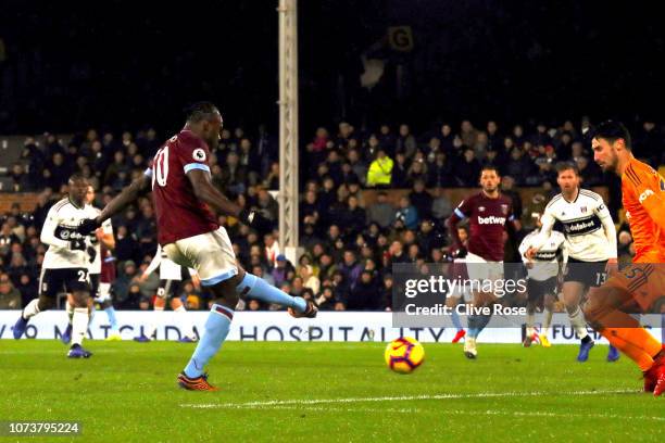 Michail Antonio of West Ham United scores his team's second goal past Sergio Rico of Fulham during the Premier League match between Fulham FC and...