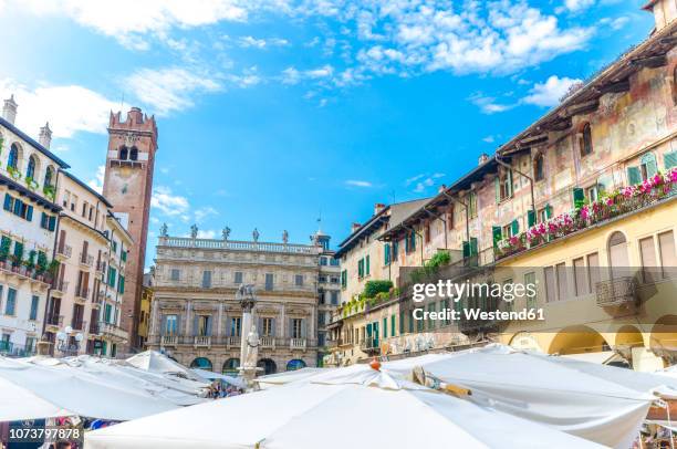 italy, verona, view to piazza delle erbe with stalls and torre del gardello in the background - market square stock pictures, royalty-free photos & images