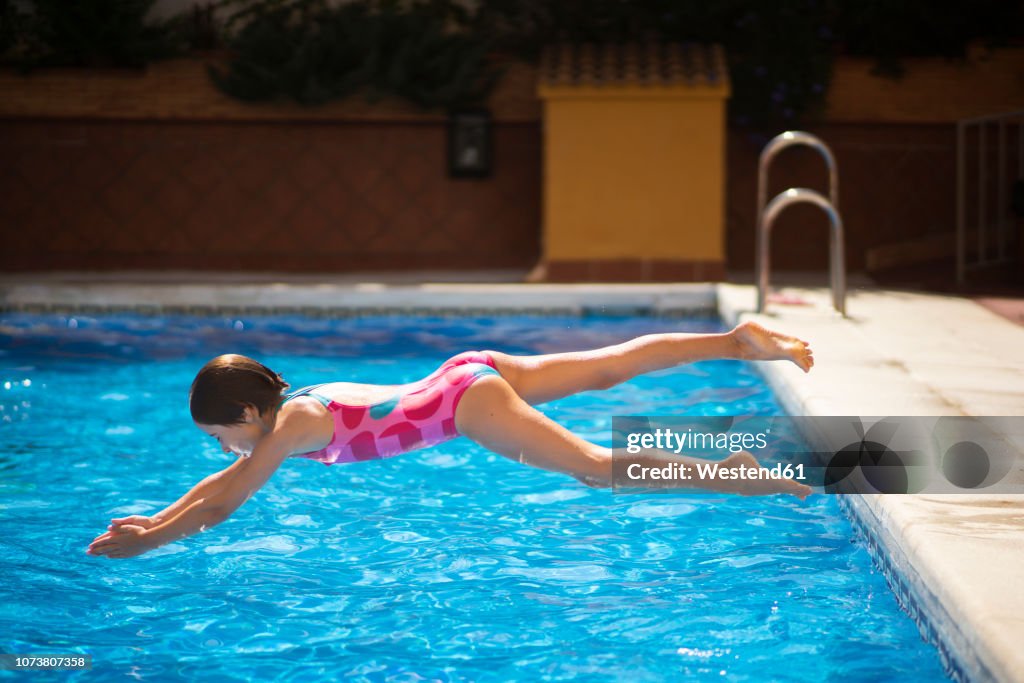 Jump Head First Young Girl Jumping Head First Into The Pool In Summer High-Res Stock ...