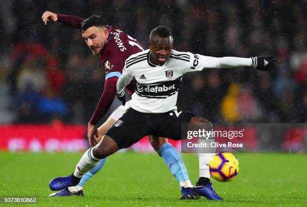 Jean Michael Seri of Fulham battles for possession with Robert Snodgrass of West Ham United during the Premier League match between Fulham FC and...