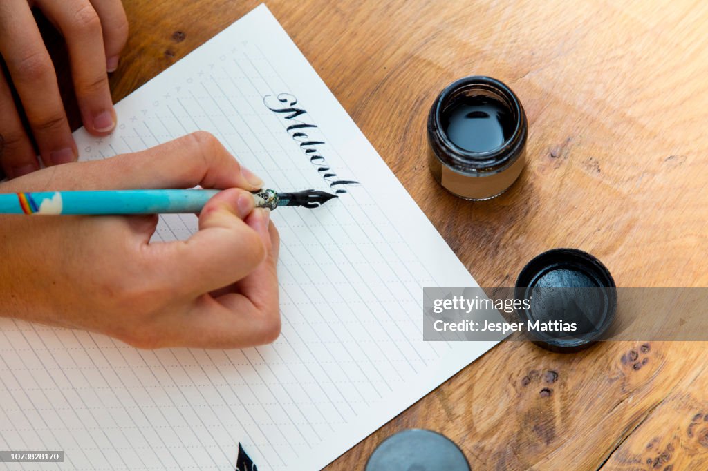Woman writing with calligraphy pen