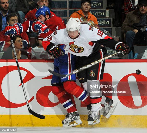 Jesse Winchester of the Ottawa Senators checks Roman Hamrlik of the Montreal Canadiens during the NHL game on December 7, 2010 at the Bell Centre in...