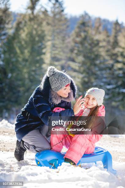 mother applying skin cream to her daughter for protection from the cold - winter skin stock pictures, royalty-free photos & images