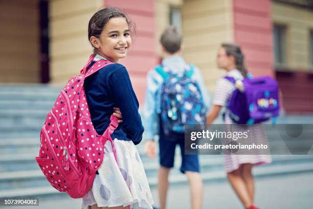 portrait of a girl entering the school - entering school stock pictures, royalty-free photos & images